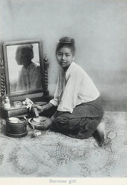 A Burmese girl preparing her make-up