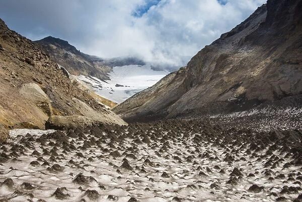 Little sand mounds on a glacier field on Mutnovsky volcano, Kamchatka, Russia, Eurasia