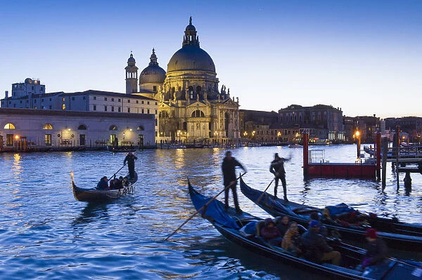 Gondolas and Santa Maria della Salute at dusk. Venice, Veneto, Italy