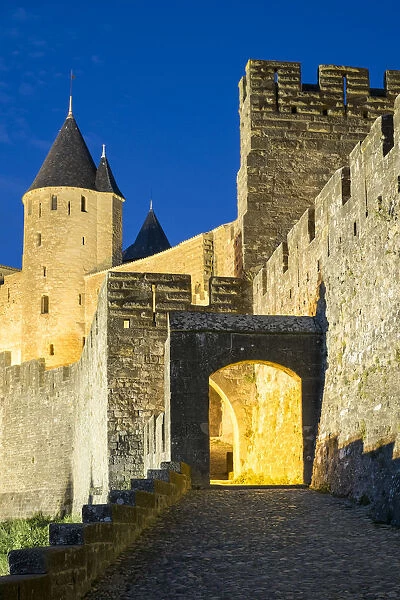 Porte d Aude city gates entrance to medieval citadel of La Cite at night