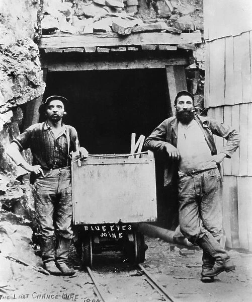 LAST CHANCE MINE, 1882. Two miners wearing Levi Strauss blue jeans at the entrance