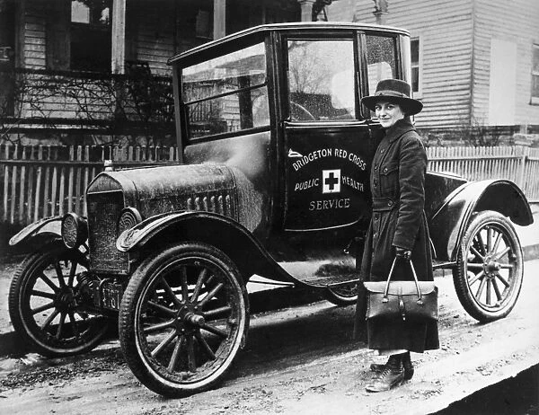 A Red Cross nurse with a new Model T Ford, in Bridgeton, Massachusetts. Photograph, 1916
