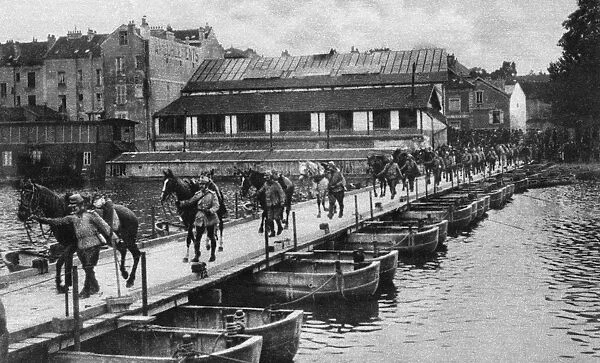 WORLD WAR I: PONTOON BRIDGE. French cavalrymen leading their horses over a pontoon