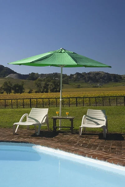 Argentina, Tandil, poolside sun loungers below sunshade at Hosteria Ave Maria