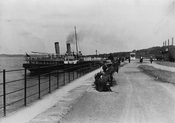 Lazy Days. A pleasure steamer berthed and people on a quayside bench