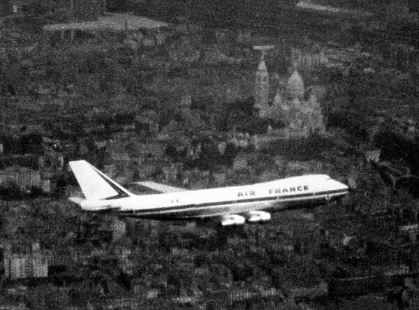 An Air France Boeing 747 make first flight over Paris, Montmartre and Basilica of the Sacre Coeur