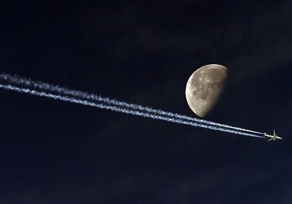 Jetliner Vapour Trail Passing the Moon