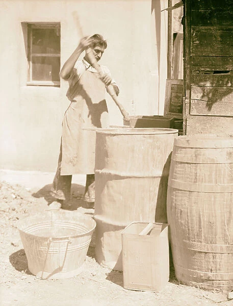 Soaking clay barrels water man stick stirring
