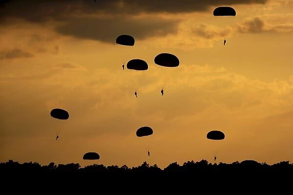 U. S. Army Soldiers parachute through the sky