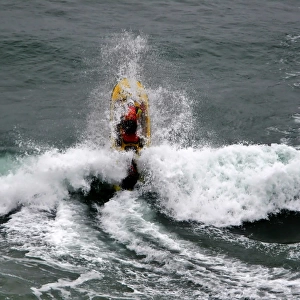 An RNLI lifeguard on a rescue water craft at Perranporth