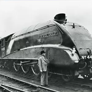 Nigel Gresley standing alongside his A4 class steam engine
