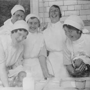 Nurses bathing babies