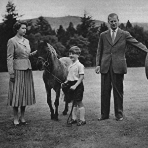 The Queen and Prince Philip play with their children, ponies