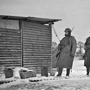 Two soldiers at a camp in winter