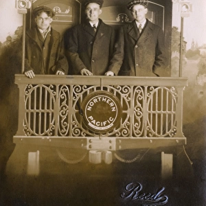 Studio photo, three young men on Northern Pacific train