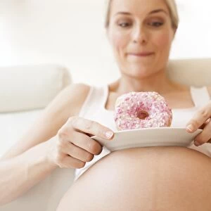 Pregnant woman with doughnuts