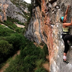 Climber makes her way up one of the rock faces of the celebrated Mascun Gorge