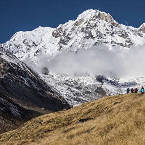 A group of Trekkers approaching Annapurna Base Camp, with Annapurna South looming