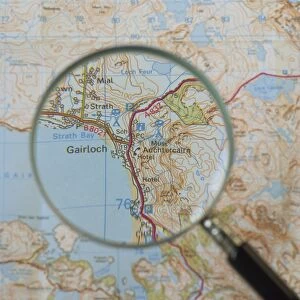 Magnifying glass above an Ordnance Survey map