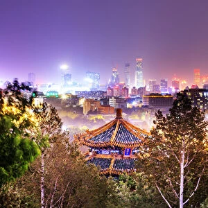 China, Beijing, pagoda and skyscrapers in the background illuminated by city lights