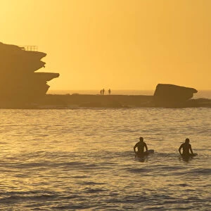 Surfers at Bondi Beach at sunrise, Sydney, New South Wales, Australia