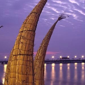 Totora (reed) boats are stacked along the beach