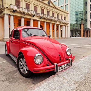 Uruguay, Montevideo, Red Volkswagen Beetle parked in front of the Estevez Palace