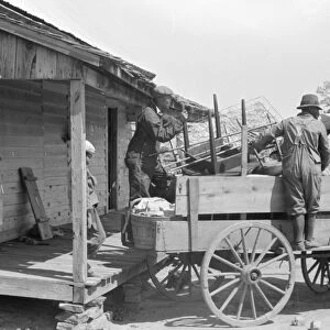 GEORGIA: DAY LABORERS. A day laborer loading his possessions on a wagon near Madison, Georgia