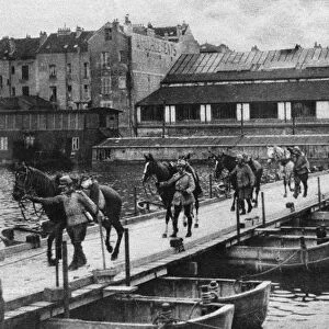 WORLD WAR I: PONTOON BRIDGE. French cavalrymen leading their horses over a pontoon