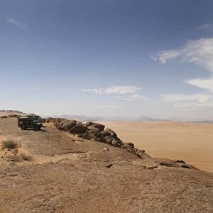 4X4 Vehicles Overlooking a Vast Desert Landscape
