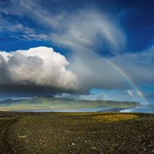 Clouds and rainbow over the seashore, Iceland