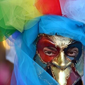 A costumed reveller poses near Saint Marks square during the carnival on February 21