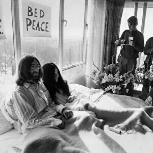 John Lennon and his wife Yoko Ono Receiving Journalists