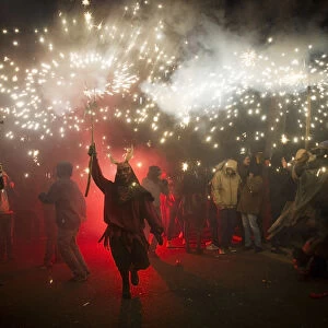 A reveller wearing a demon costume takes part in the traditional festival of Correfoc"