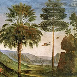 Man leaning on a staff, birds flying, trees, rocks, a lake and a distant city with spires