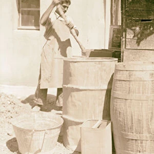 Soaking clay barrels water man stick stirring