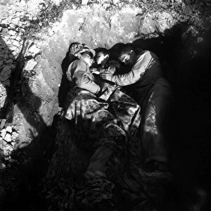 Marines share a foxhole with an orphan, Okinawa, Japan