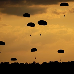 U. S. Army Soldiers parachute through the sky