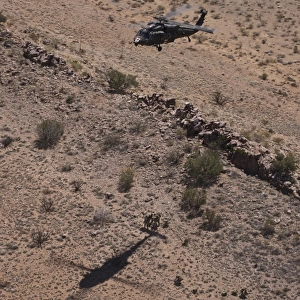 UH-60 Black Hawk hovers above U. S. Marines for extraction
