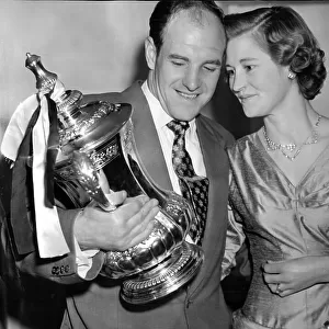 Jimmy Scoular and wife Joyce admiring the FA Cup trophy after Newcastle United victory in 1955