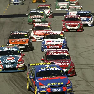 2004 Australian V8 Supercar Championship Clipsal 500, Adelaide, Australia. 21st March 2004. Ford driver Marcos Ambrose leads the field into the first corner at the start of race 2