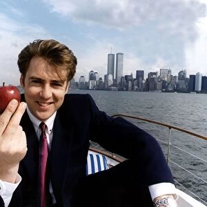 Jonathan Ross TV Presenter on a boat on the Hudson river in New York holding an apple