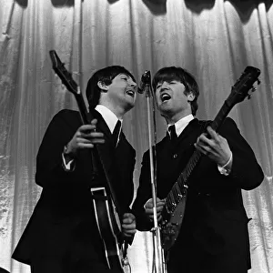 Paul McCartney & John Lennon of The Beatles perform on stage November 1964