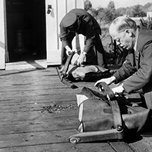 Post Office workers prepare the fitted pouches ready for the quick-release nets so