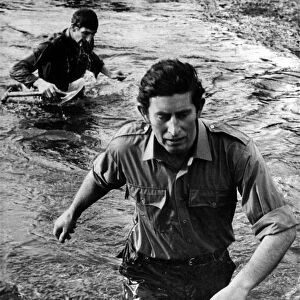 Running tall. Prince Charles wades along a stream. January 1975 P009343