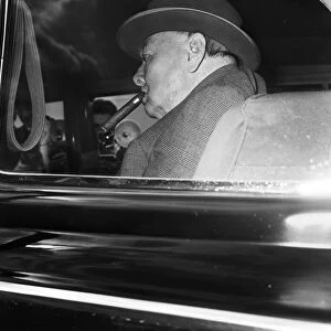 Winston Churchill pictured at London airport as he returns to England from holiday in