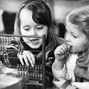 These young girls learn the art of calculating with the help of a abacus