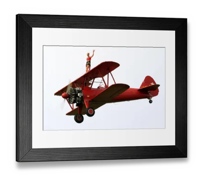 Framed Print : A wing-walker prerforms on a Boeing Stearman Pt13 during the WAG 2009 (World Air