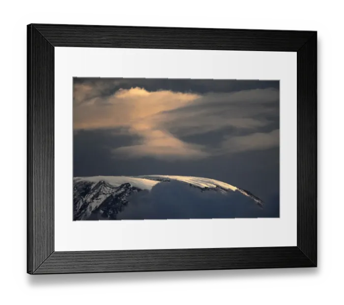 Framed Print : The ice cap in Africas highest mountain, Mt. Kilimanjaro gleams on December 13, 2009 Framed Print : The ice cap in Africas highest mountain, Mt. Kilimanjaro gleams on December 13, 2009