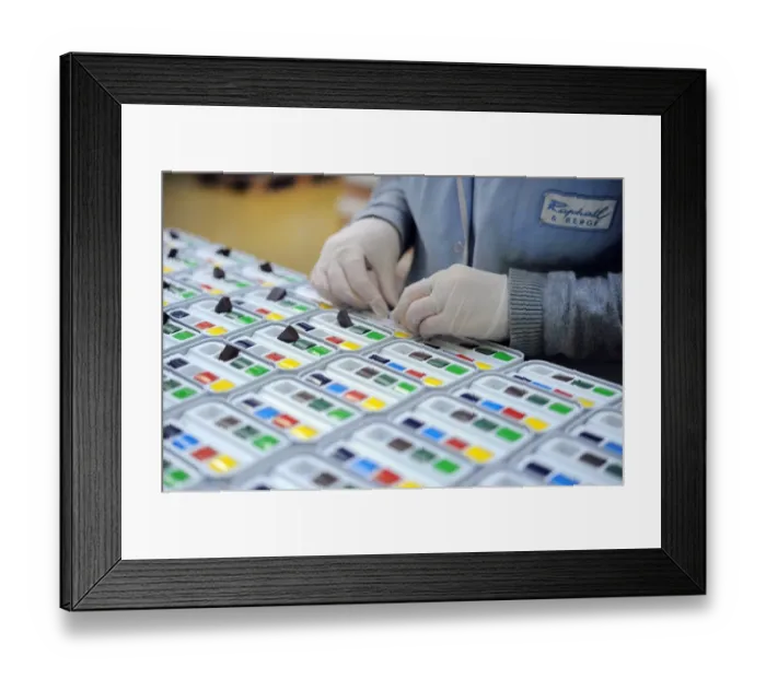 Framed Print : An employee fills pastel boxes in a workshop at the Raphael-Isabey-Sennelier factory